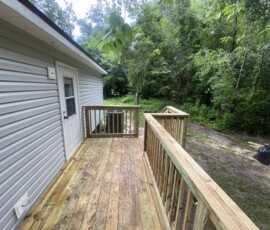 Deck and railing Wooden deck and railings alongside a home