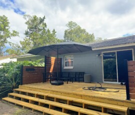 Original deck and steps Original wooden deck with wide steps and privacy screens beside the home