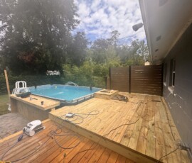 Pool deck extension in progress New deck boards and steps beside the pool during construction
