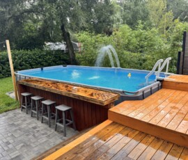 Completed pool deck extension Finished pool deck extension with wooden steps and a poolside counter