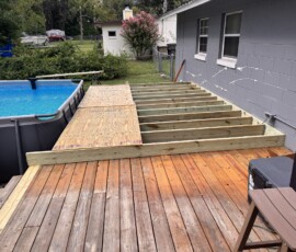 Pool deck extension framing Exposed timber joists for a deck extension beside a pool